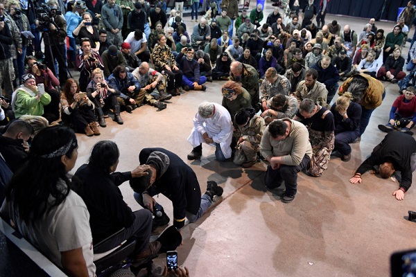Gen. Wesley Clark Jr.,  kneels in front of Leonard Crow Dog, right, during a forgiveness ceremony at the Four Prairie Knights Casino & Resort on the Standing Rock Sioux Reservation on December 5, 2016 in Fort Yates, North Dakota. Native Americans conducted a forgiveness ceremony with U.S. veterans at the Standing Rock casino, giving the veterans an opportunity to atone for military actions conducted against Natives throughout history. The ceremony was held in celebration of Standing Rock protestersÕ victory SundayÊin halting construction on the Dakota Access Pipeline.  Leonard Crow Dog formally forgave Wes Clark Jr., the son of retired U.S. Army general and former supreme commander at NATO, Wesley Clark Sr. Helen H. Richardson, The Denver Post